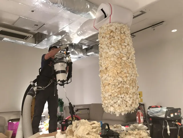 Lincoln Air Duct Cleaning technician performing precision vacuum insulation removal in a residential property in Lincoln